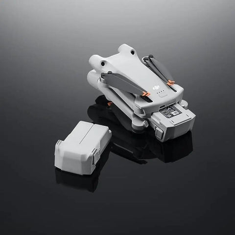 Intelligent Flight Battery Plus For Mini 4 Pro Mini 3 And Mini 3 Pro 3850mAh High Capacity Drone Battery next to folded drone