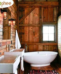 Rustic wooden bathroom with freestanding oval bathtub, dual sinks, and natural light from a window.