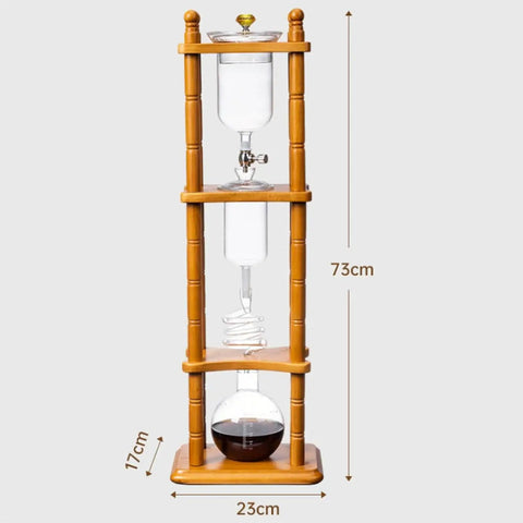 720 Milliliter Cold Brew Coffee Tower With Adjustable Valve Makes Five To Seven Cups featured with wooden stand and glass components.