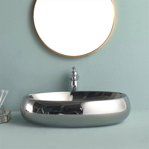 USZWBY Bathroom Vessel Sink European Ceramic Sink Art Basin Chrome Wash Basin Oval Sink Bathroom Sink Above Counter Basin with Faucet,Silver Bathro on a blue backdrop.