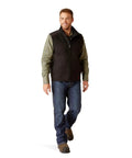 Men's Tough As Nails Fire Resistant Insulated Vest Black Large worn by man with jeans and plaid shirt, ideal for outdoor work.