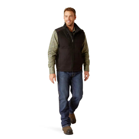 Men's Tough As Nails Fire Resistant Insulated Vest Black Large worn by man with jeans and plaid shirt, ideal for outdoor work.