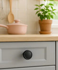Close-up of a 10 Pack Matte Black Cabinet Knobs 1-1/4 Inch Modern Zinc Alloy Hardware For Kitchen Cabinets on a drawer