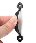 Hand holding a 3 inch black barn door handle from the 12 Pack Rustic Barn Door Handles Do It All Black 3 Inch Gate Pulls For Cabinets Closets Garage Drawers Indoor Outdoor Use 66mm Hole To Hole Screws Included