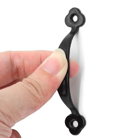 Hand holding a 3 inch black barn door handle from the 12 Pack Rustic Barn Door Handles Do It All Black 3 Inch Gate Pulls For Cabinets Closets Garage Drawers Indoor Outdoor Use 66mm Hole To Hole Screws Included