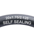 Close-up of Self Sealing Bike Inner Tubes 20x1.75 to 2.125 AV32mm With Schrader Valve text on black rubber surface