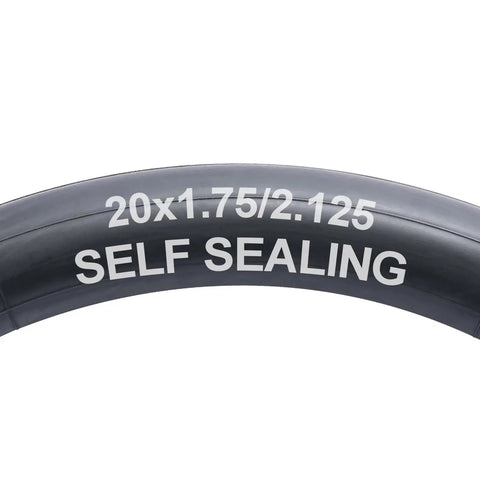 Close-up of Self Sealing Bike Inner Tubes 20x1.75 to 2.125 AV32mm With Schrader Valve text on black rubber surface