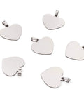 Heart-shaped stainless steel pendant charms, 33mm, silver-tone with snap-on bails; set of ten on white background
