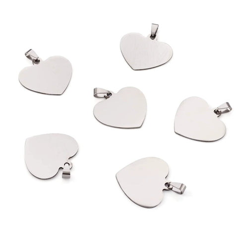 Heart-shaped stainless steel pendant charms, 33mm, silver-tone with snap-on bails; set of ten on white background