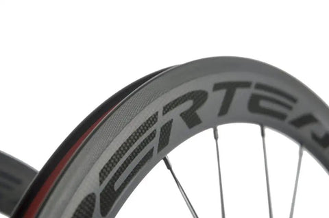 Close-up of Carbon Fiber Road Bike Wheelset 700C Clincher, 50mm Deep Rim, showcasing matte finish and transparent decal.