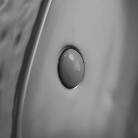 Close-up view of matte black oval vessel sink 23.5 by 15.7 inches, ceramic countertop bathroom basin with pop up drain detail.