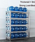 Heavy Duty Stainless Steel Four Tier Storage Shelves With Brushed Commercial Grade Finish Built Like A Tank For Kitchen Pantries Garages And Warehouses Top Shelf Workspace Organizer Rack with stacked water bottles.