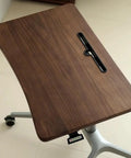 Upgrade Your Home Office Setup With This Smooth Riding Mobile Standing Desk That Dials In Your Perfect Height Fast For Seamless Sit Or Stand Flexibility Wherever You Roll, close-up of walnut top.