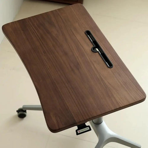 Upgrade Your Home Office Setup With This Smooth Riding Mobile Standing Desk That Dials In Your Perfect Height Fast For Seamless Sit Or Stand Flexibility Wherever You Roll, close-up of walnut top.