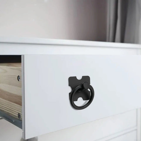 Black vintage style drawer pull with square back plate on white dresser, highlighting antique design and functionality.