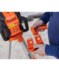 Jobsite Ready Self Leveling Red Dual Slope Rotary Laser System With 4,000 Ft Range on tripod with remote control in hand