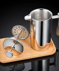 Premium Stainless Steel French Press Plunger Filter Replacement For 34oz Coffee Maker on a wood tray with mesh screen.