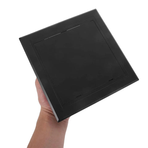 Slick Black Plastic Wall Access Panel Swings Open For Easy Inspections held in hand, showcasing smooth finish and quick snap design.