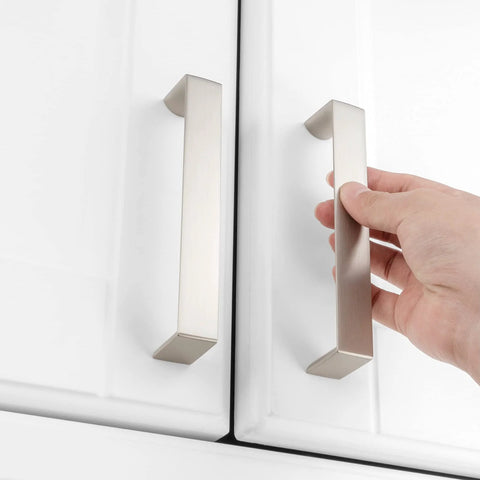 Hand installing 10 Pack 5 Inch Brushed Nickel Cabinet Pulls Satin Silver Cabinet Handles on white kitchen drawers