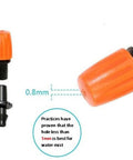 Close-up of orange adjustable drip heads from 50 Piece Garden Micro Flow Drippers Sprinklers Emitter Set With Adjustable Drip Heads