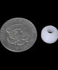20 Piece White Woodworking Pen Bushings Set non-stick bushing beside a half dollar coin for size comparison
