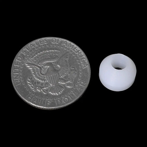20 Piece White Woodworking Pen Bushings Set non-stick bushing beside a half dollar coin for size comparison