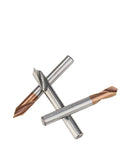 Three carbide spot drill bits with copper-colored tips and silver shanks arranged in an X