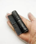 Heavy Duty Weld On Hinges 4 Pack Rock Solid Steel Hinges With Removable Pin in hand, showing black carbon steel design.