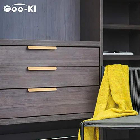 Top Shelf Pure Brass Finger Pulls With Brushed Matte Finish Hella Slim Modern Cabinet Handles Five Inch Center To Center Six Pack Rock Solid Hardware For A Slick Home Refresh on dark wood drawers.