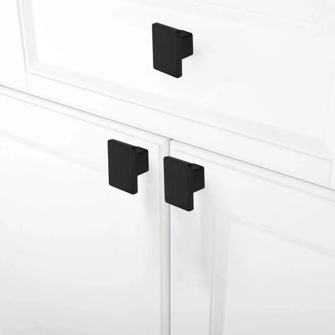 Matte black 1.57 inch square cabinet knobs on white doors, part of the 6 pack 1.57 Inch Square Cabinet Knobs Matte Black Dope Drawer Pulls
