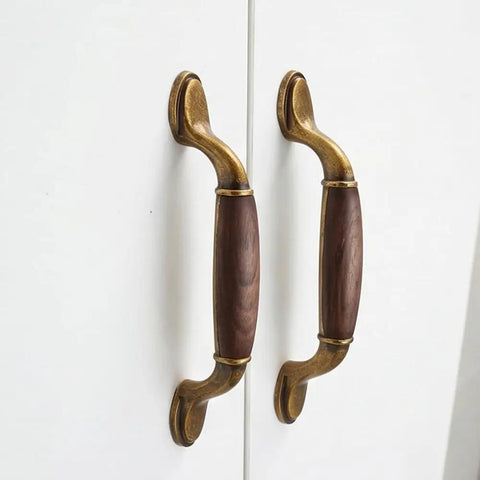 Vintage Walnut Wood Cabinet Handles Set With Zinc Alloy Drawer Pulls in Antique Metal Finish on white doors.