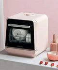 Fully Automatic Countertop Dishwasher With 5L Built In Water Tank And Inlet Hose featuring a pink compact design and plates inside.