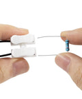 Hands holding a resistor and connector from Harness Disable Kit For Honda And Acura 3.5L V6 Engines To Disable VCM With Muzzler Tech