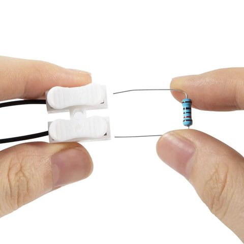 Hands holding a resistor and connector from Harness Disable Kit For Honda And Acura 3.5L V6 Engines To Disable VCM With Muzzler Tech