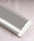 Close-up of oval furniture glide nail, silver plastic and iron, Furniture Glide Nails And Holding Pins For Legs, on wooden floor.