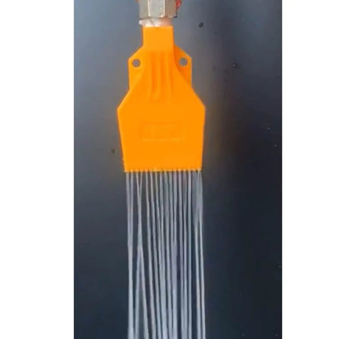Close-up of an orange nozzle from the Five Piece Wind Jet Air Nozzle Set For High Power Airflow With Flat Fan Spray Nozzles And Water Cooling Spray ABS Plastic Nozzles Includes Quarter Inch Connectors Great For Spray Blowing And DIY Projects showing water spray pattern.