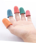 Colored neoprene finger sleeves on hand for grip, part of 30 Pack Neoprene Finger Sleeves Heat Resistant Protective Covers With Non Slip Grip Durable Work Gear For Mechanics No Sweat Protection For Tough Industrial Job Sites.