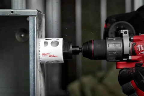 Milwaukee 4-inch ice-hardened hole saw installed on cordless drill for metal cutting