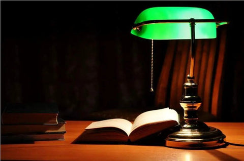 Classic green banker lamp on wooden desk with open book, compatible with Led T10 120V 5W Frosted Dimmable Glass Bulb 2 Pack For Piano Light.