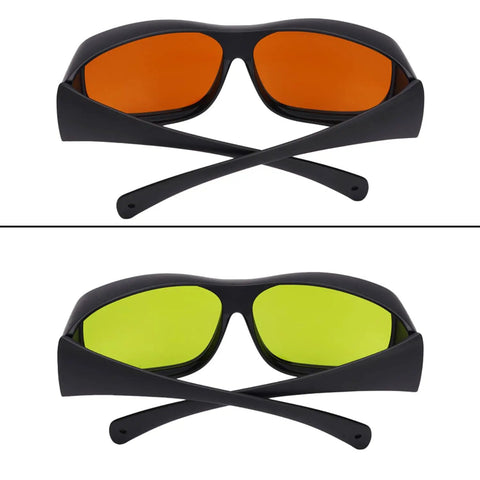 Professional Grade Kickass Laser Safety Glasses With Hella Od5 Plus Eye Defense Across One Hundred Ninety To Eleven Hundred Nanometer Wavelength Range For Spa Studios And Beauty Clinics In Classic Orange Lens both orange and green lenses shown, black frame, crossed behind.