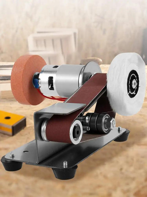 Rock Solid Mini Belt Sander Boasting 7 Easy Speed Gears For Quick Polishing And Sharpening Plus An Integrated Knife Sharpener For Wood And Metal Hobbyists on a workbench with sanding wheels.