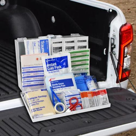 First Aid Kit, 178 pieces, white, opened in a pickup truck bed with assorted medical supplies.