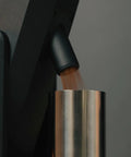 Dope Stepless Coffee Grinder Featuring 40mm Stainless Steel Conical Burrs For Pulling Consistent Espresso Shots And Brewing Smooth Daily Drips With Hella Low Retention In Matte Black pouring ground coffee into a silver hopper.