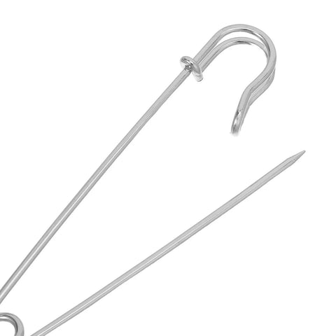 Close-up of a heavy duty iron safety pin, featuring a sharp end and secure clasp, perfect for outdoor adventures.