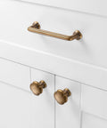 Antique Brass Cabinet Pulls 10 Pack With 3-3/4 Inch Hole Centers, Vintage Brass Handles For Cabinets, Drawers, Dressers, Vanity, Closet, Kitchen, Durable Rust-Resistant Metal Hardware. Shown installed on a white cabinet.