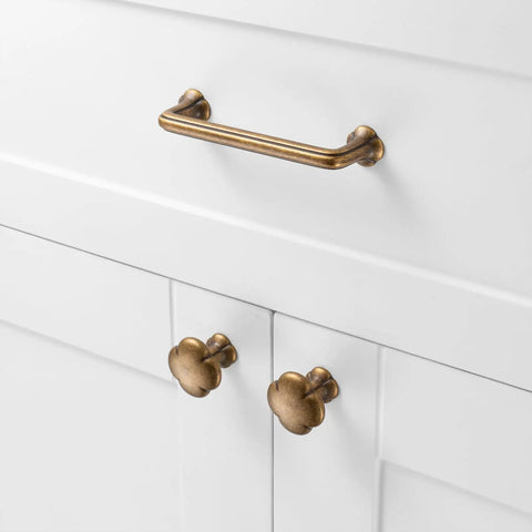 Antique Brass Cabinet Pulls 10 Pack With 3-3/4 Inch Hole Centers, Vintage Brass Handles For Cabinets, Drawers, Dressers, Vanity, Closet, Kitchen, Durable Rust-Resistant Metal Hardware. Shown installed on a white cabinet.