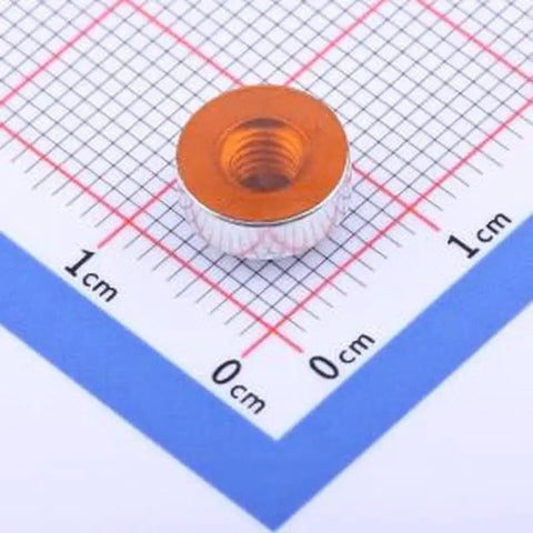 Top Shelf Solid Build Hardware Copper Tinned Smd Round Nut Spacer M4 X3 on measuring grid for PCB projects.