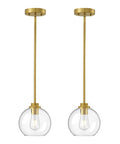 Two Pack Slick Vintage Pendant Lights With Clear Glass Globes And Gleaming Gold Canopies Adjustable Drop Length Perfect For Kitchen Islands Dining Rooms Emitting A Cozy Vibe Hardwired Installation.
