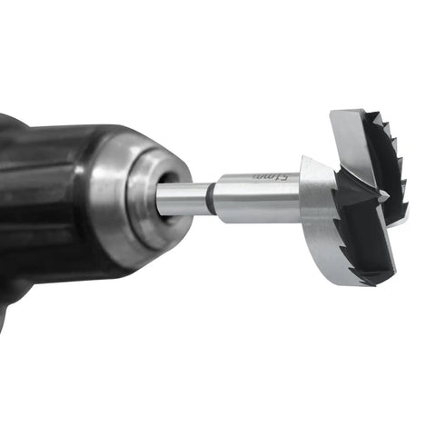Close-up of Top Tier 2 Inch Forstner Drill Bit Robust Carbon Steel Build in a drill chuck for woodworking tasks.