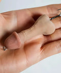 Penis Prank Fishing Hook Realistic Novelty Lure held in hand, flesh-tone gag gift with sharp treble hooks for anglers' humor.